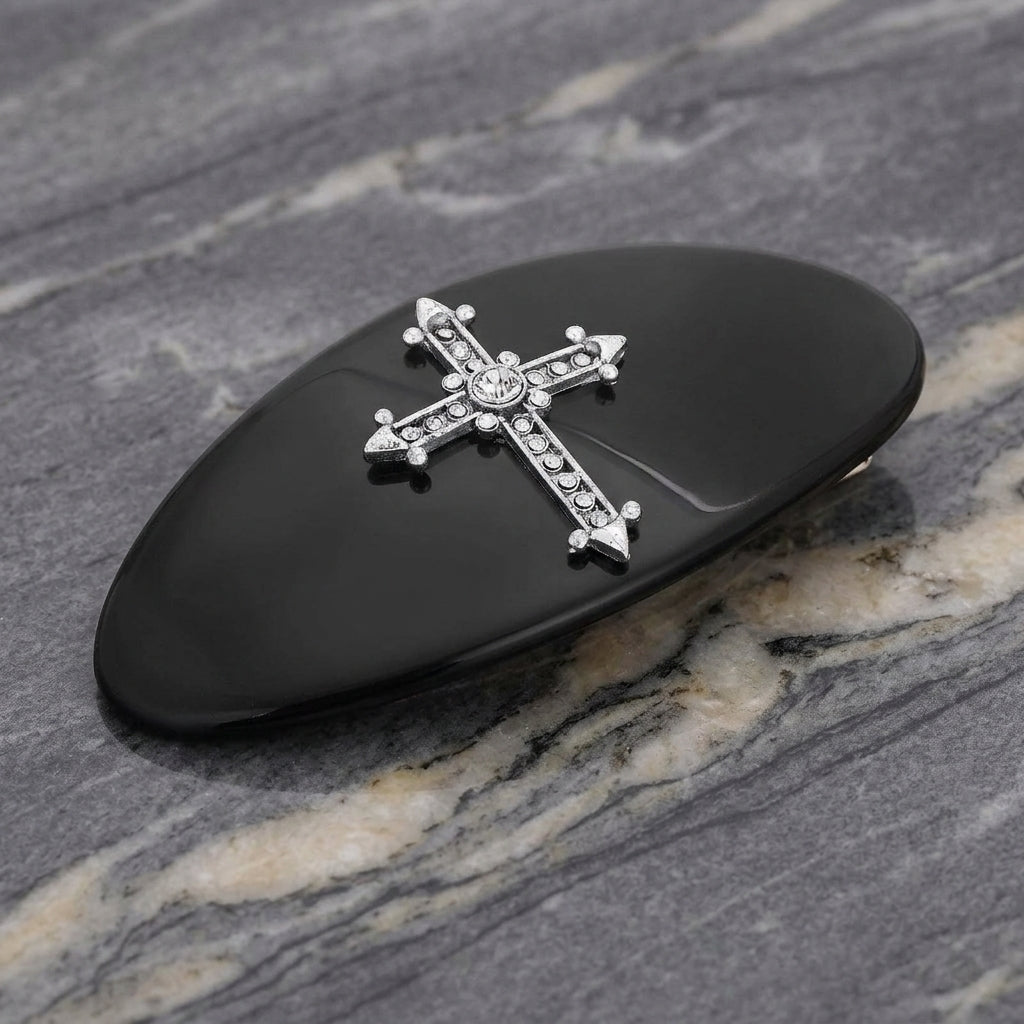Oval Jet Black Pewter Crystal Cross Hair Barrette on a marble surface