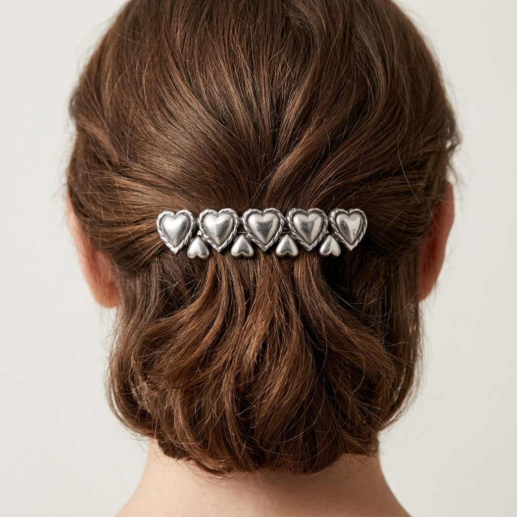 Silver Polished Hearts Hair Barrette on a person's brown hair against a neutral background