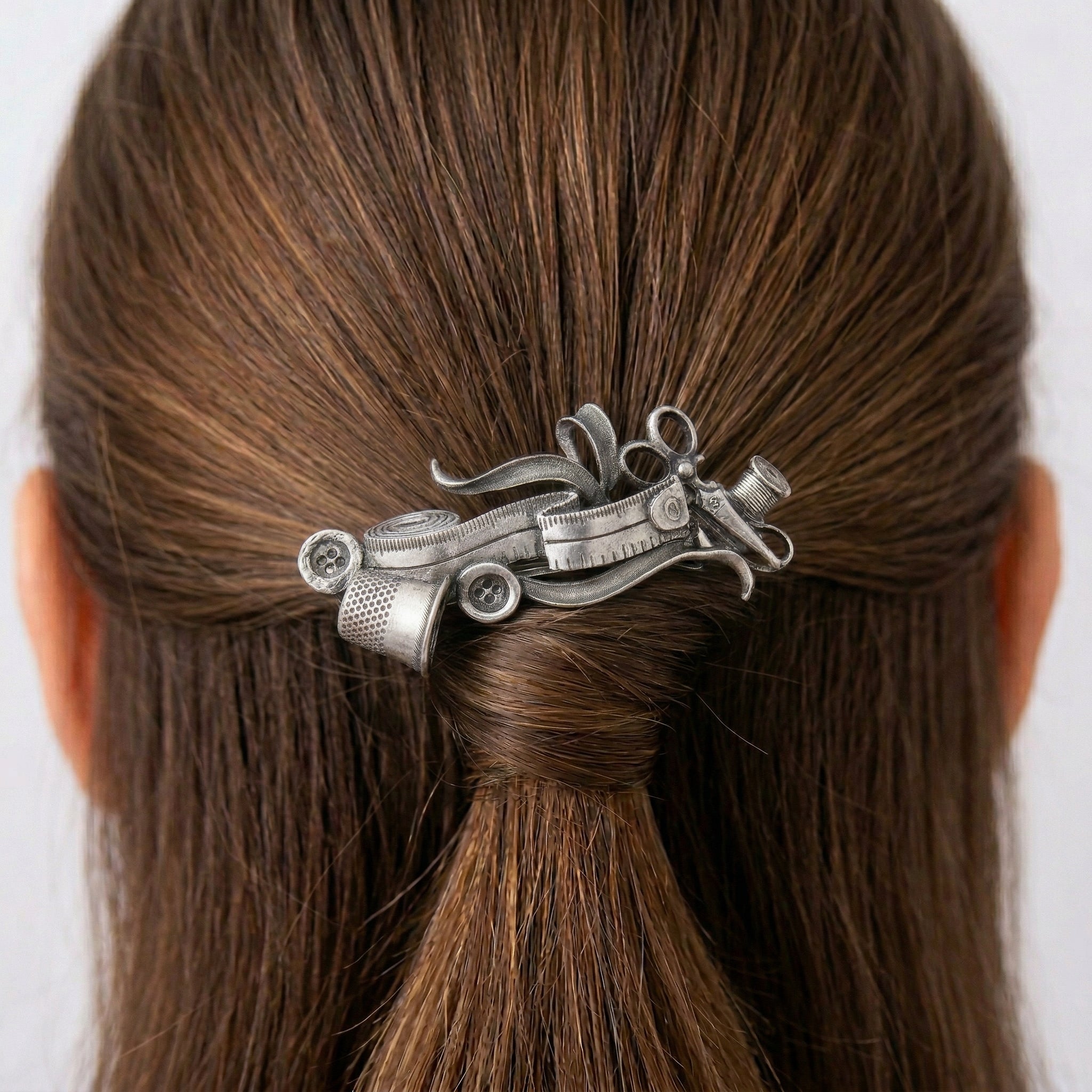 Silver tome Seamstress Essentials Hair Barrette in a person's hair