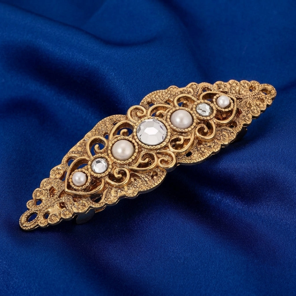 Splendor Filigree & Stones Hair Barrette on a blue fabric background