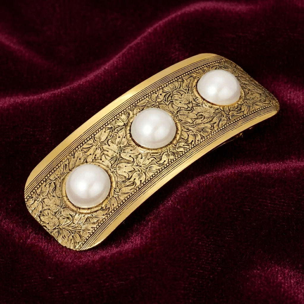 Golden Floral Etched Faux Pearls Hair Barrette on red fabric