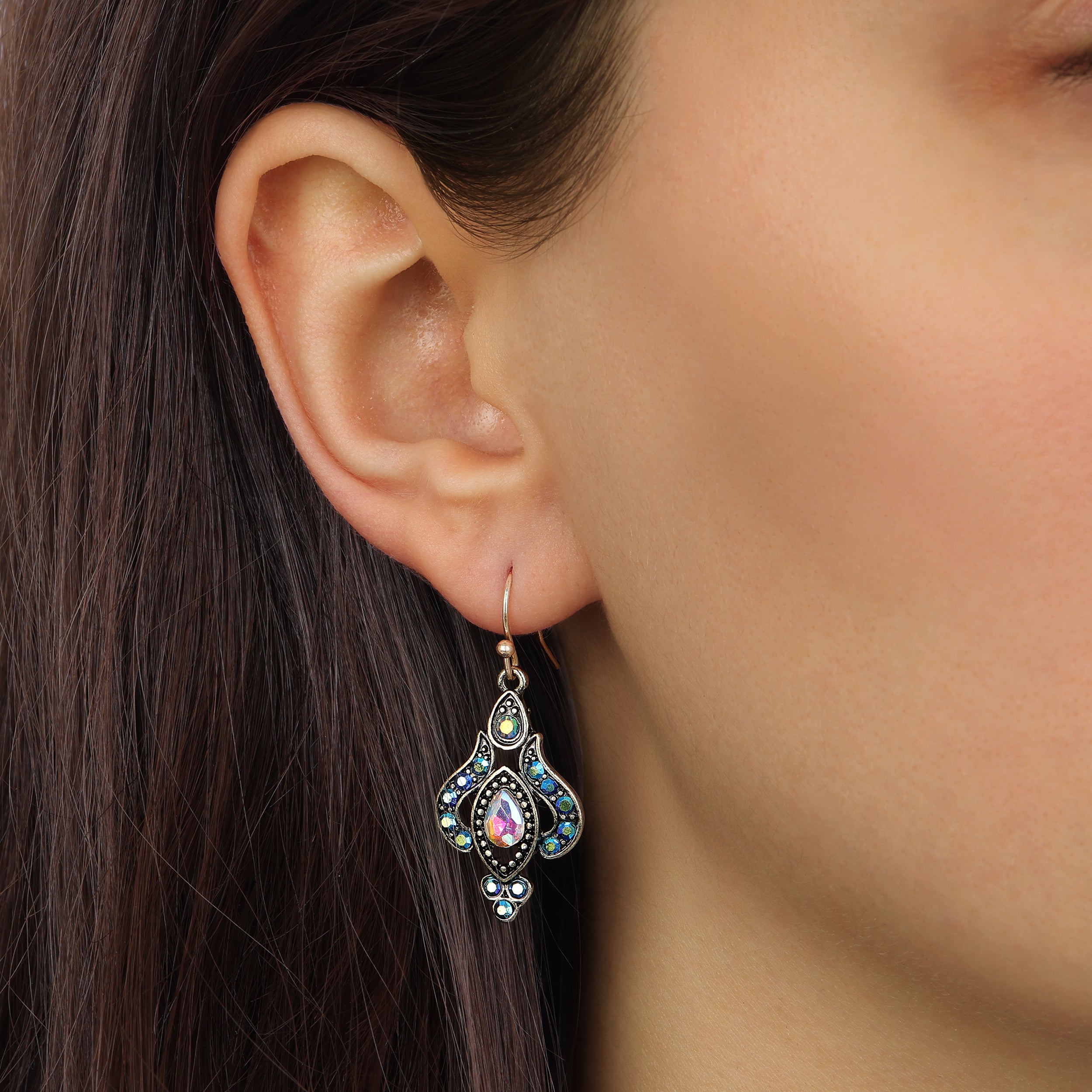 Up close look at a female model wearing our Gold Tone Iridescent AB Crystal & Blue Stone Teardrop Wire Earrings
