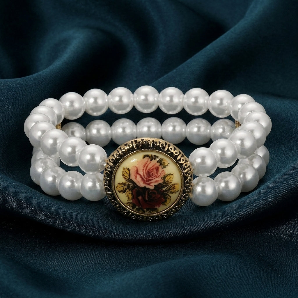 Gold Tone Red & Pink Flower Decal Double Strand Pearl Bead Stretch Bracelet on a dark blue fabric background