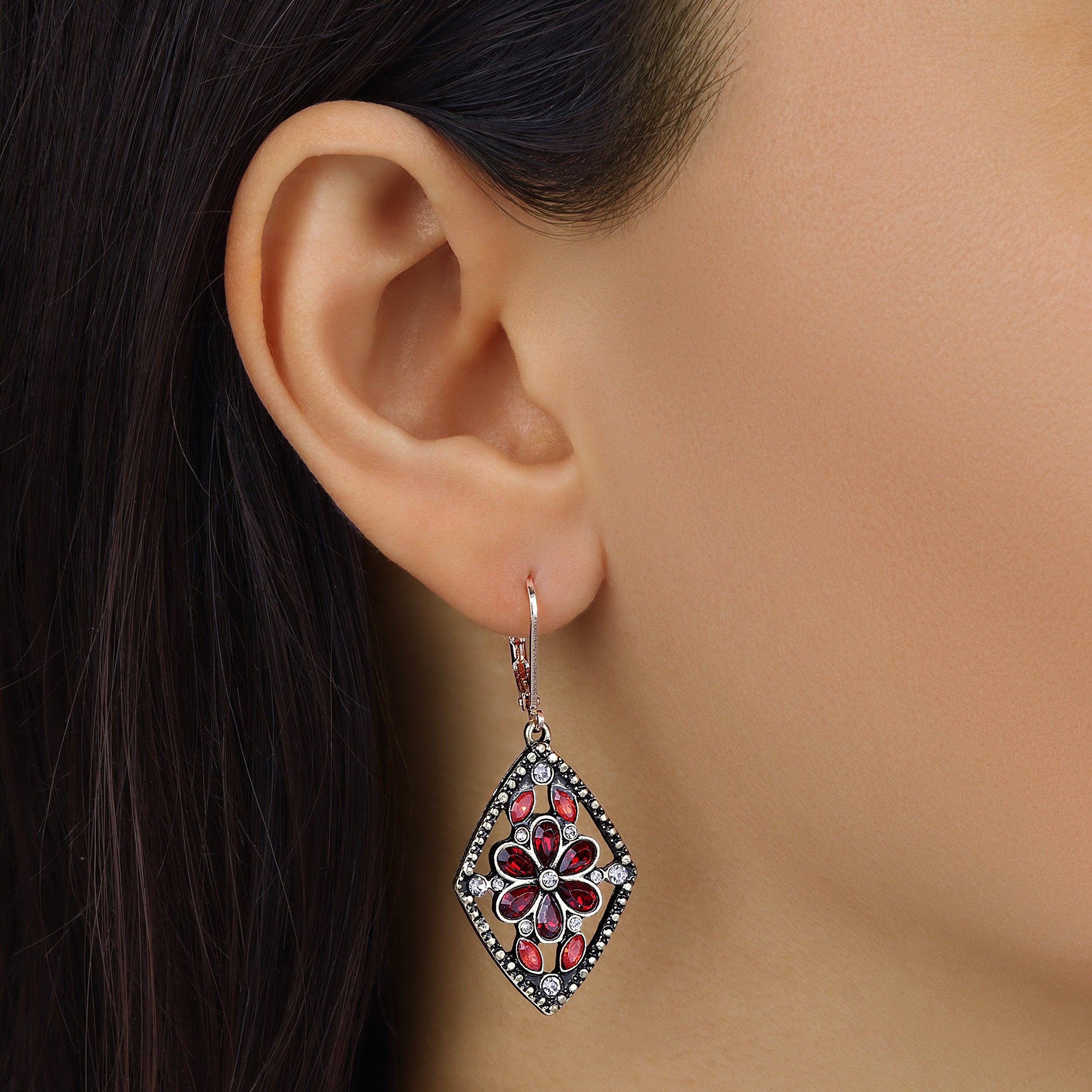 Close up of a woman wearing Diamond Shaped Flower Red Crystal Drop Earrings