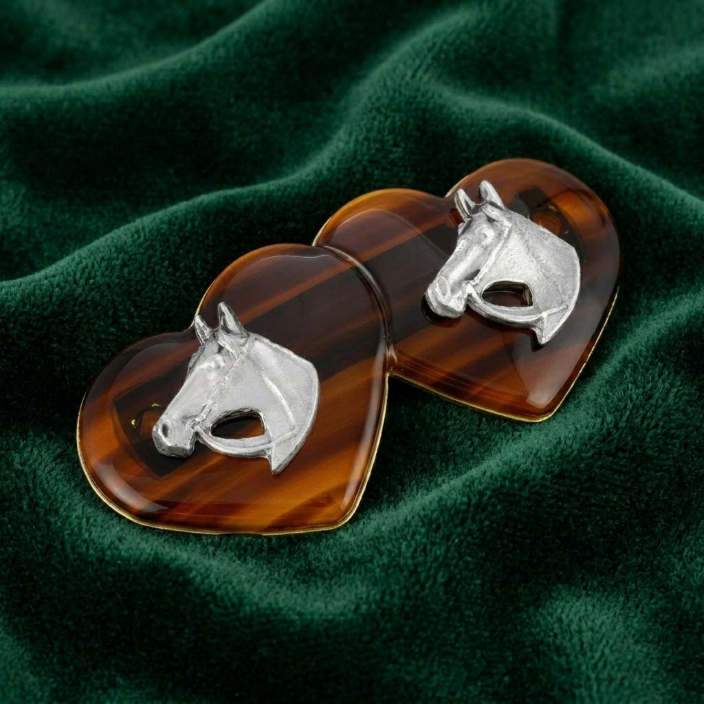Brown Tortoise Double Heart Horse Head Hair Barrette on a green fabric background