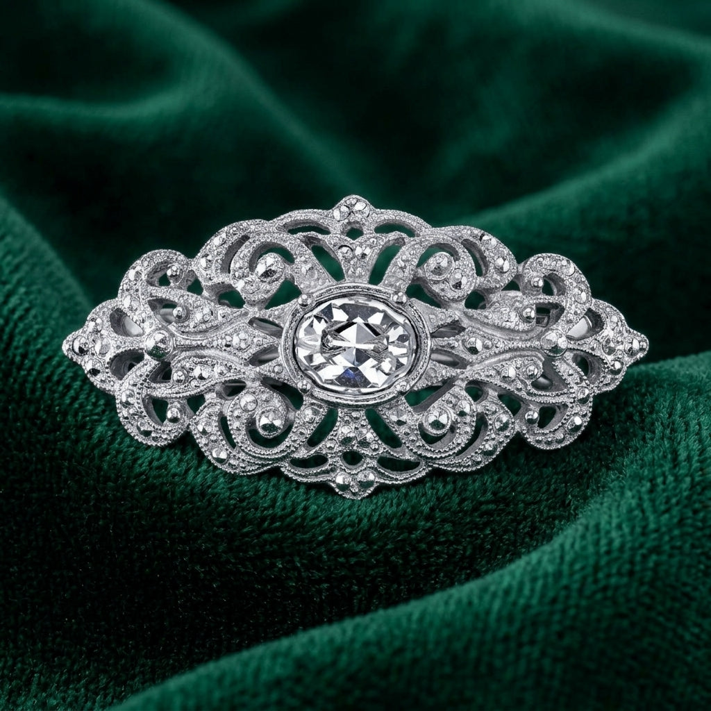 Filigree Austrian Oval Crystal Hair Clip Barrette on a green fabric background