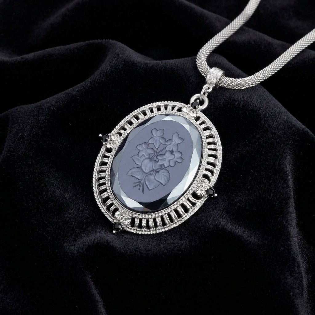 Black Intaglio Floral Stone Black & Clear Crystal Pendant Necklace on a black fabric background