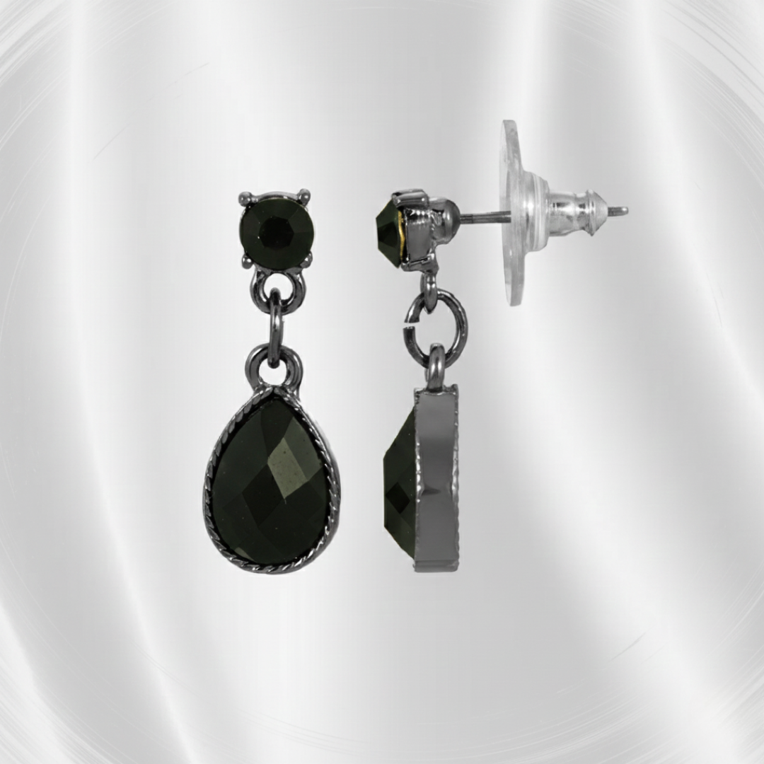 Pair of black teardrop and stud earrings on a reflective surface.