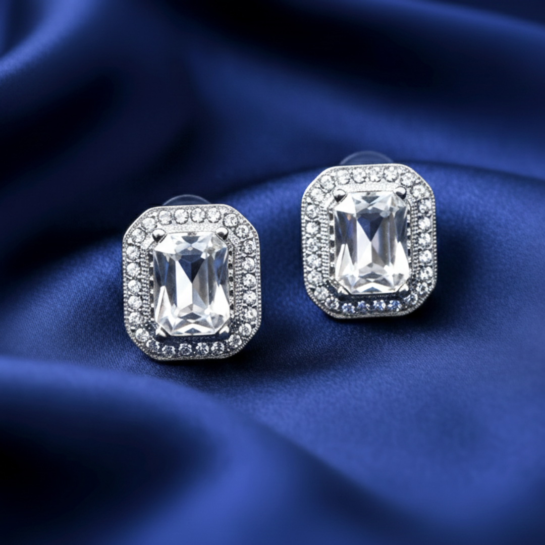 Crystal stone earrings on a blue fabric background