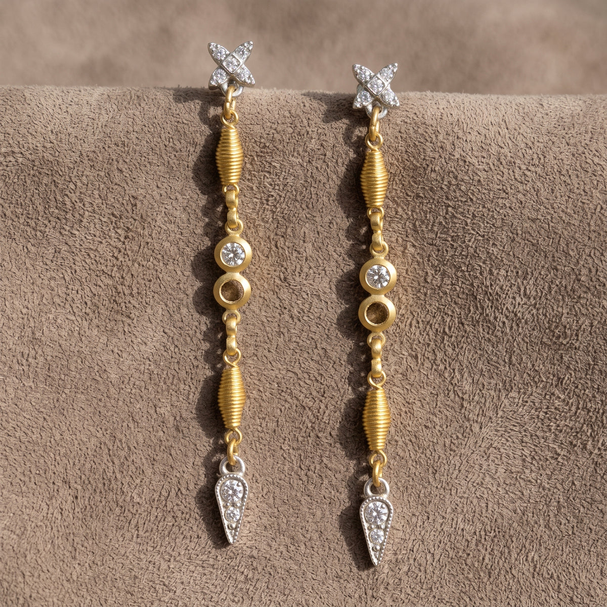 Antiquities Couture Two Tone Crystal Linear Drop Earrings on warm brown suede