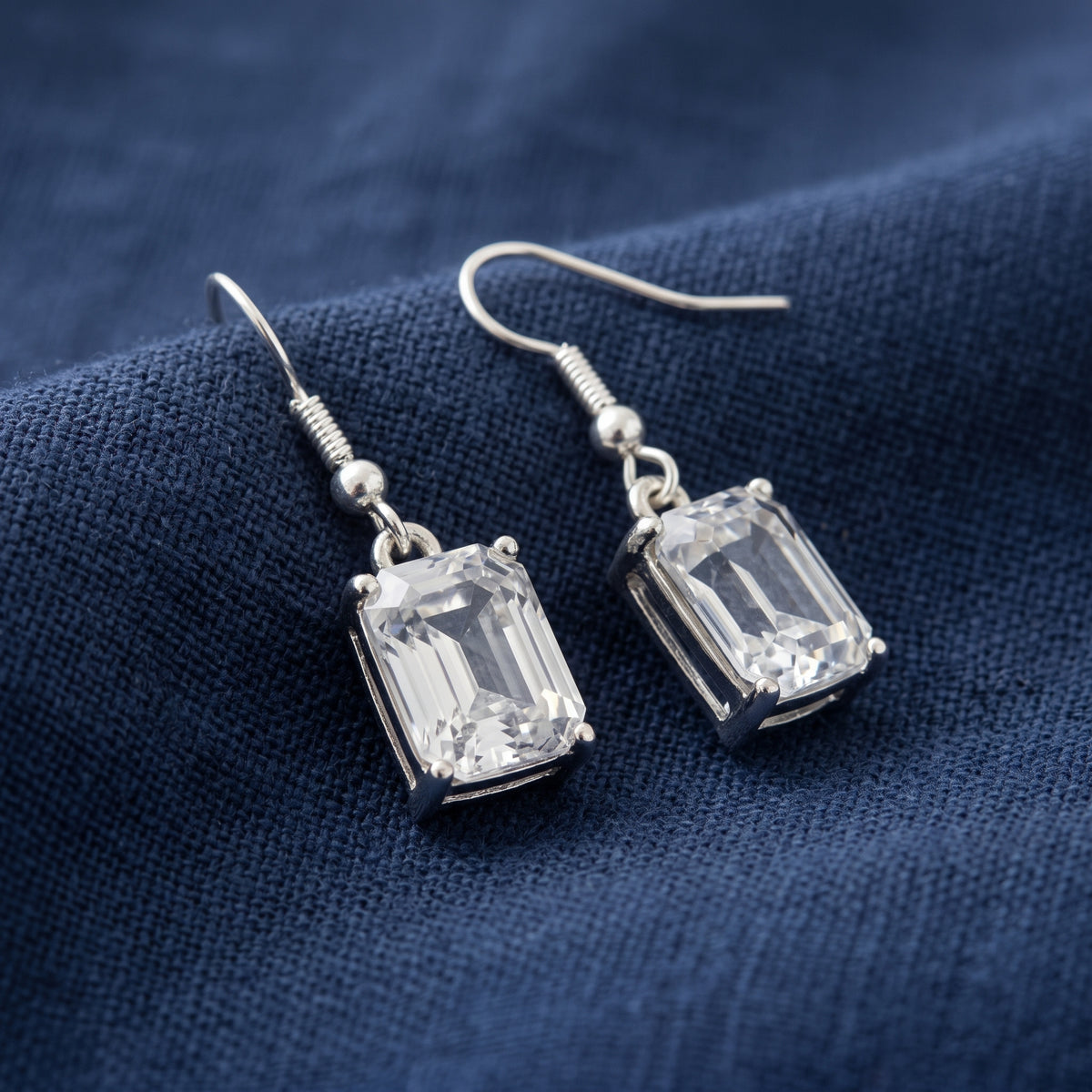 Octagon Austrian Crystals Drop Earrings on navy blue linen
