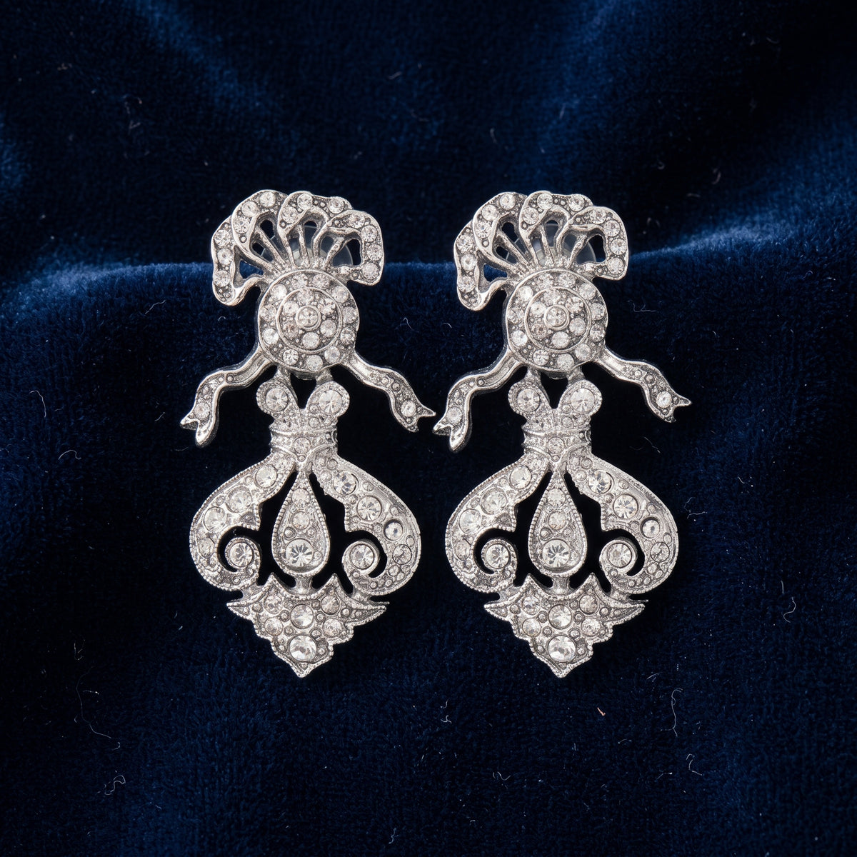 Antiquities Couture St. James Eternity Club Pave Crystal Drop Earrings displayed on dark navy blue velvet