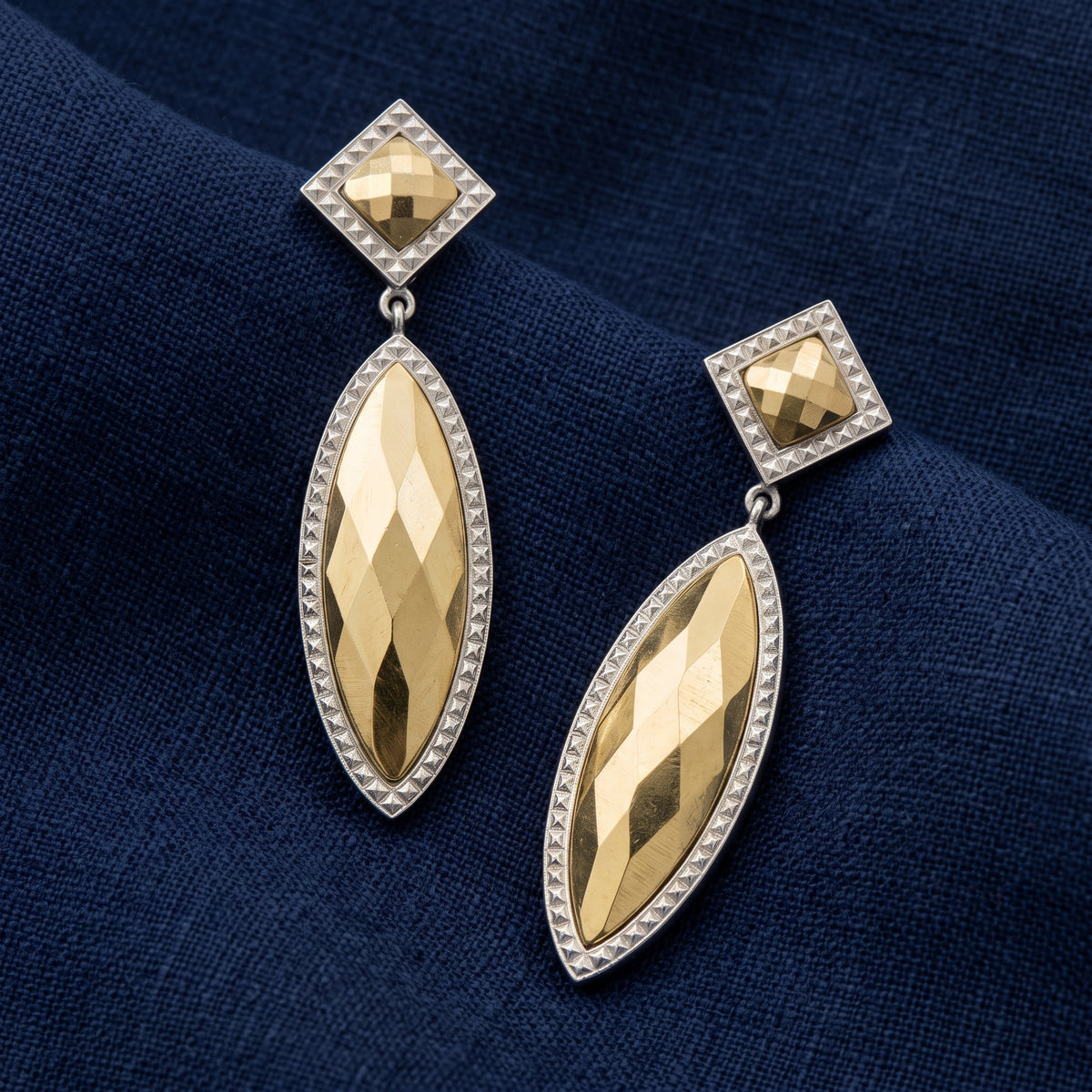 Large Fusion Lux Marquise & Square Cut Drop Earrings resting on navy blue linen