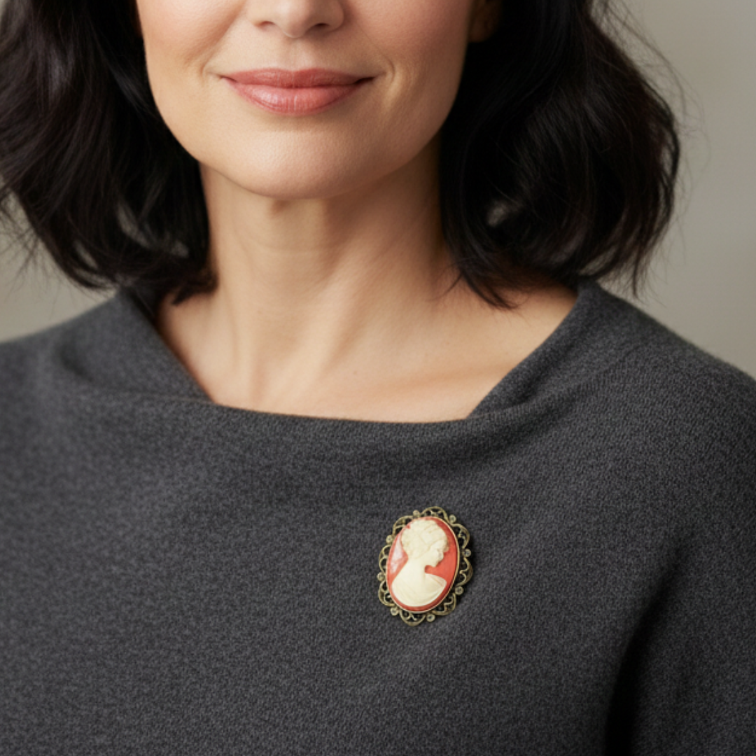 Woman wearing a dark gray sweater with a brooch on a neutral background