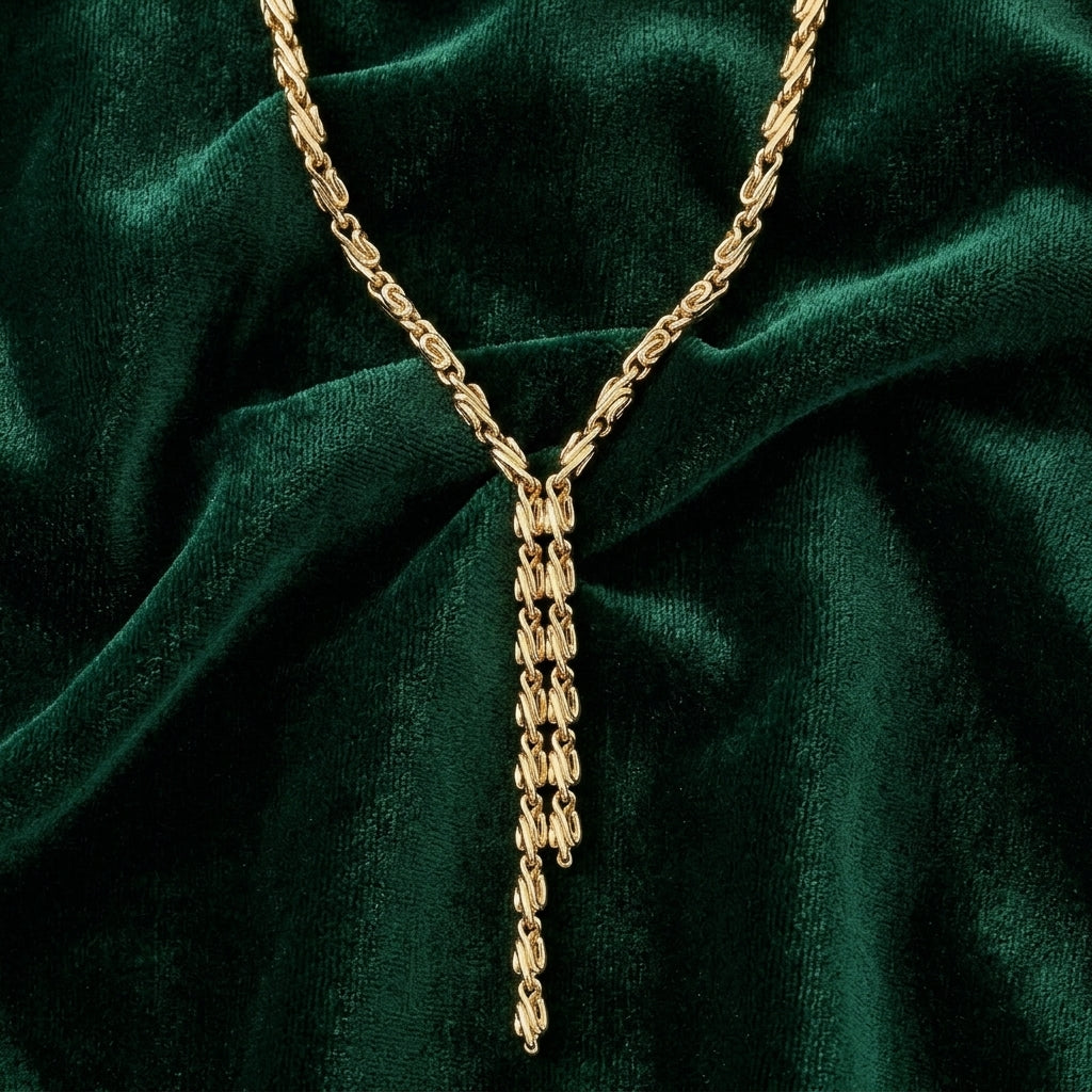 Gold Fancy Link Chain Drop Necklace on a green velvet background