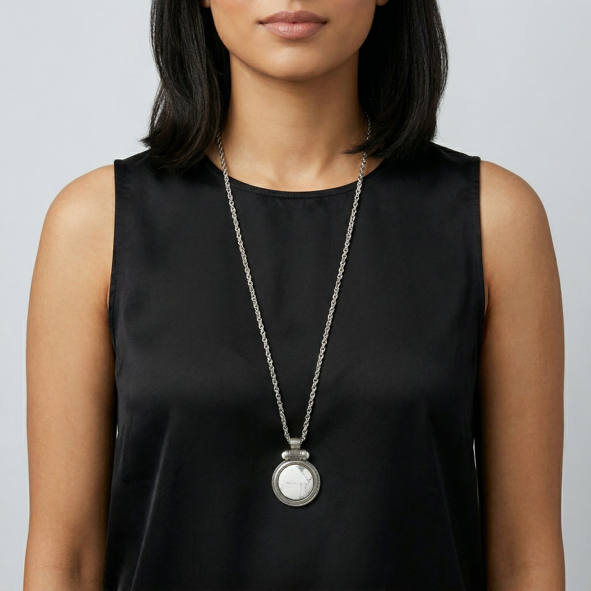 Woman wearing a black sleeveless top with a White Howlite Gemstone Pendant Necklace