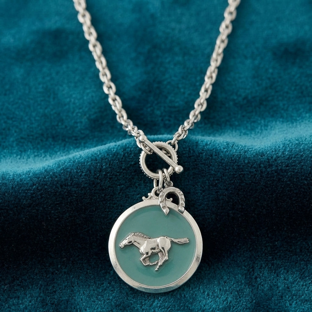 Turquoise Color Enamel Horse Pendant Toggle Necklace on teal fabric