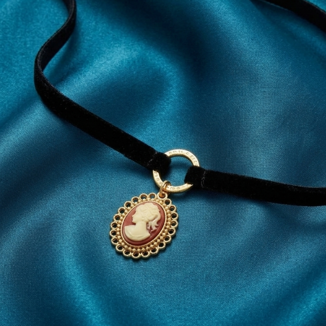 Necklace with a cameo pendant on a blue fabric background