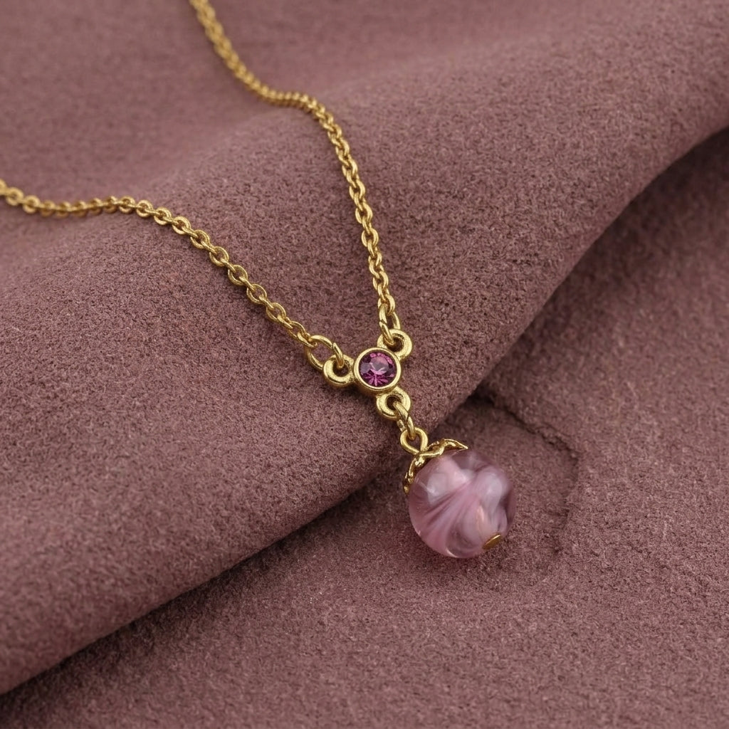 Light Amethyst Quartz Glass Round Bead Crystal Accent Drop Pendant Necklace on a dark purple fabric background
