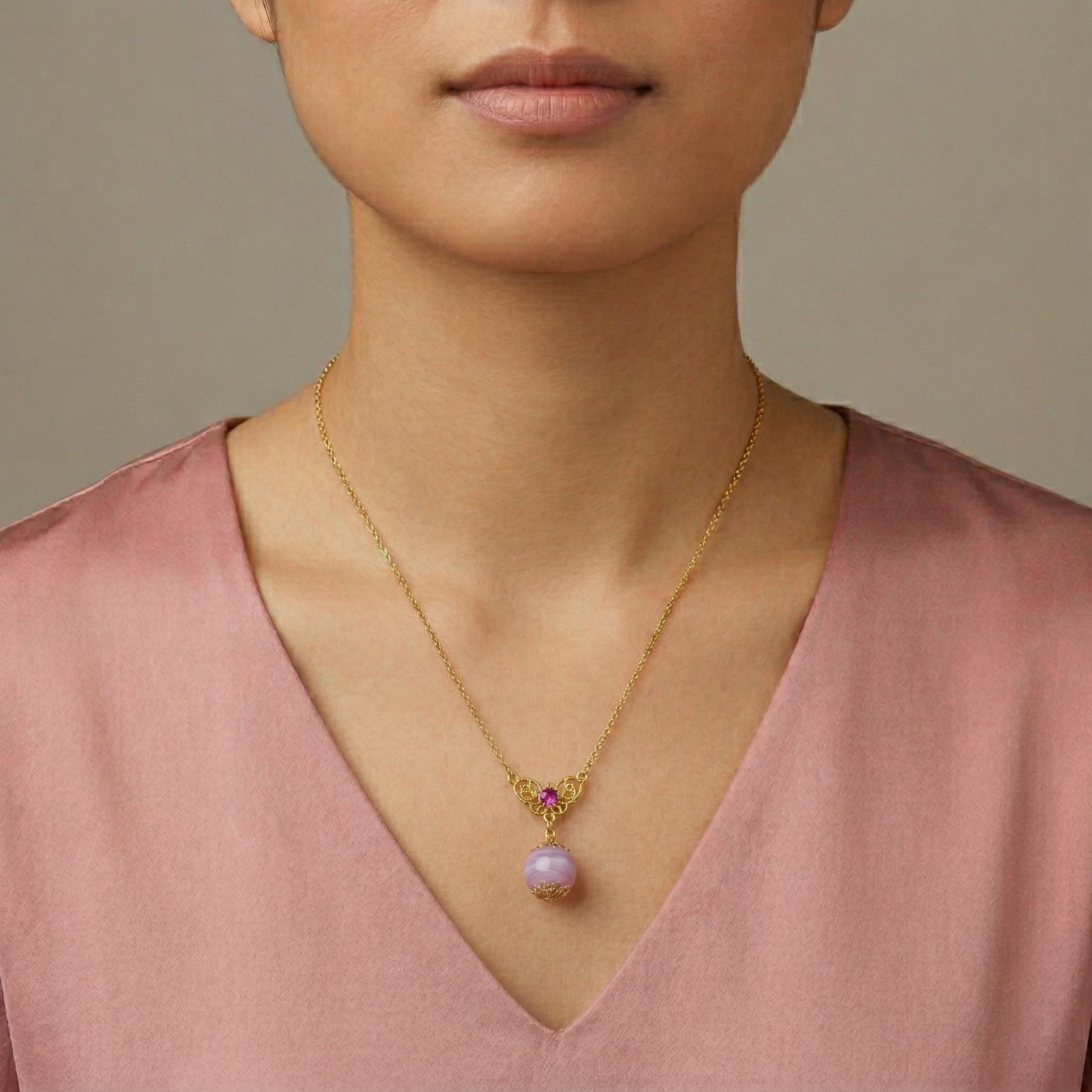 Woman wearing a Light Amethyst Quartz Glass Round Bead Crystal Accent Drop Pendant Necklace with a light purple top