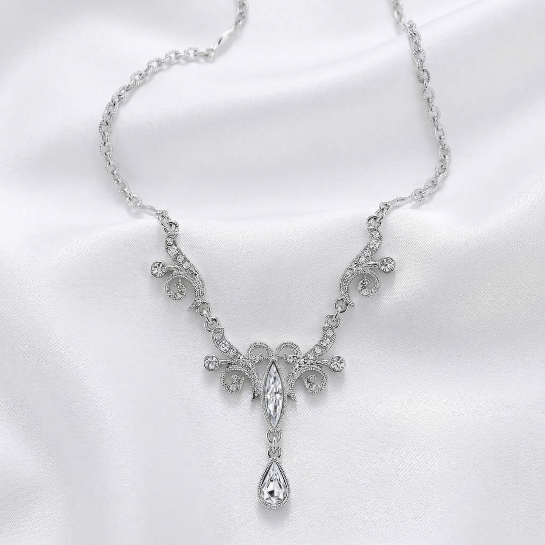 Silver necklace with a decorative clear crystals and a pendant on a white background