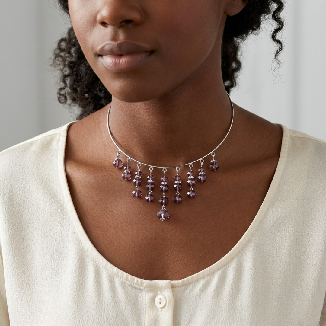 Woman wearing a choker bib necklace with purple beads against a neutral background