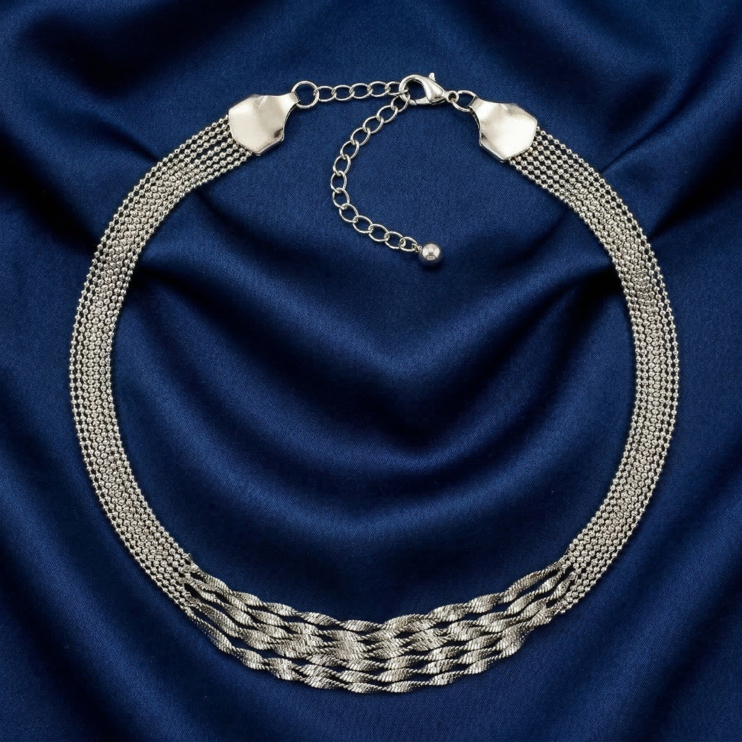 Silver necklace on a blue fabric background