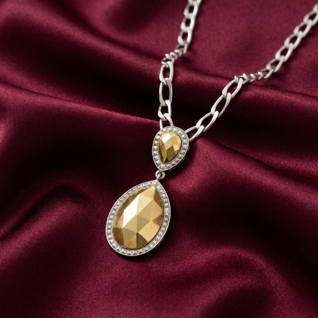 Gold fusion lux teardrop pendant necklace on a burgundy fabric background