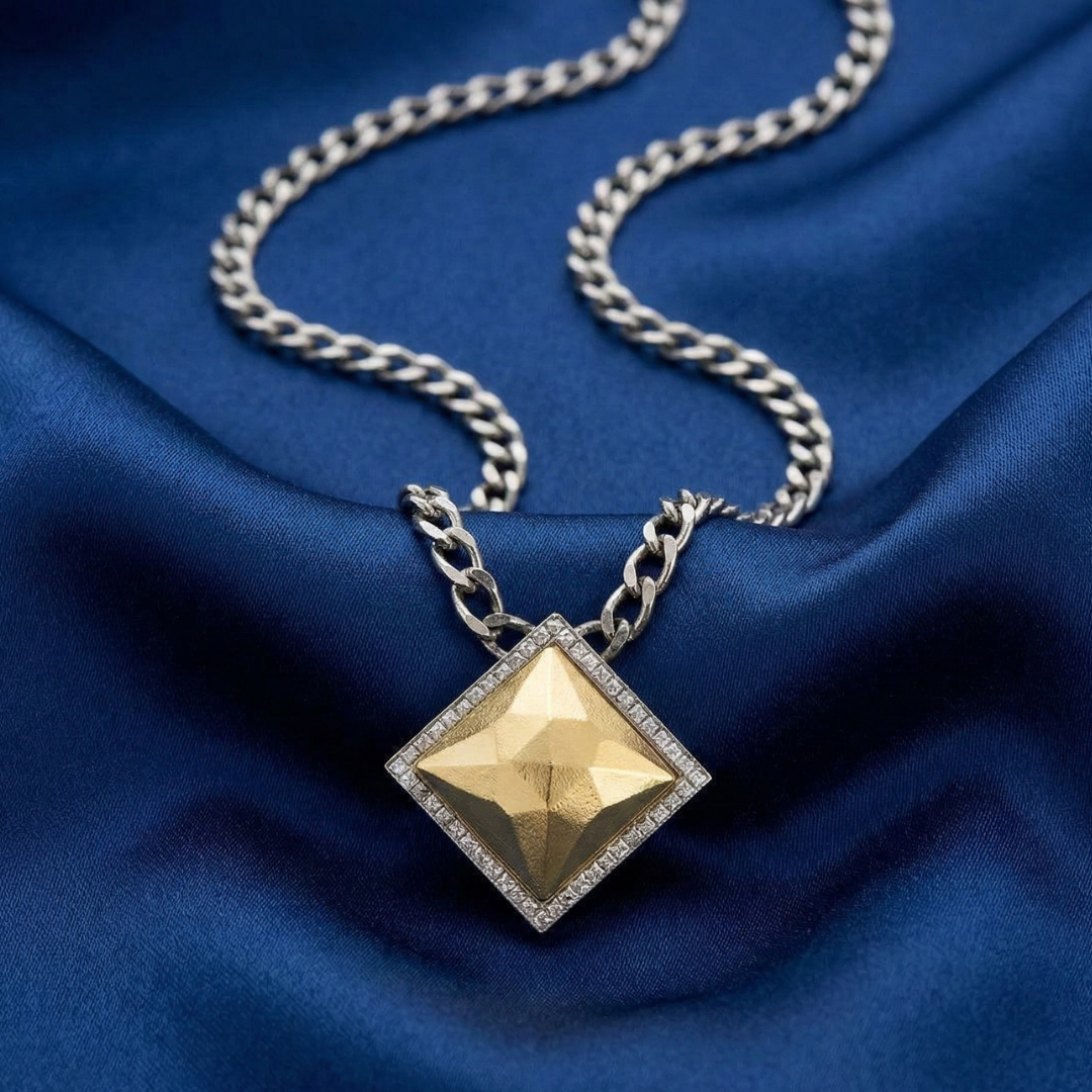 Gold fusion lux pendant necklace on a blue fabric background