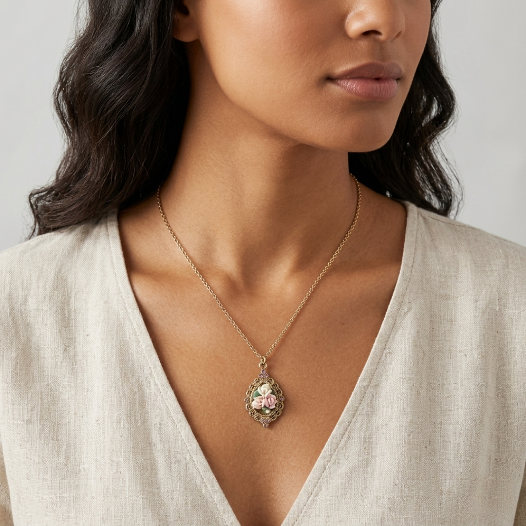 Woman wearing a delicate necklace with a floral porcelain rose pendant against a neutral background