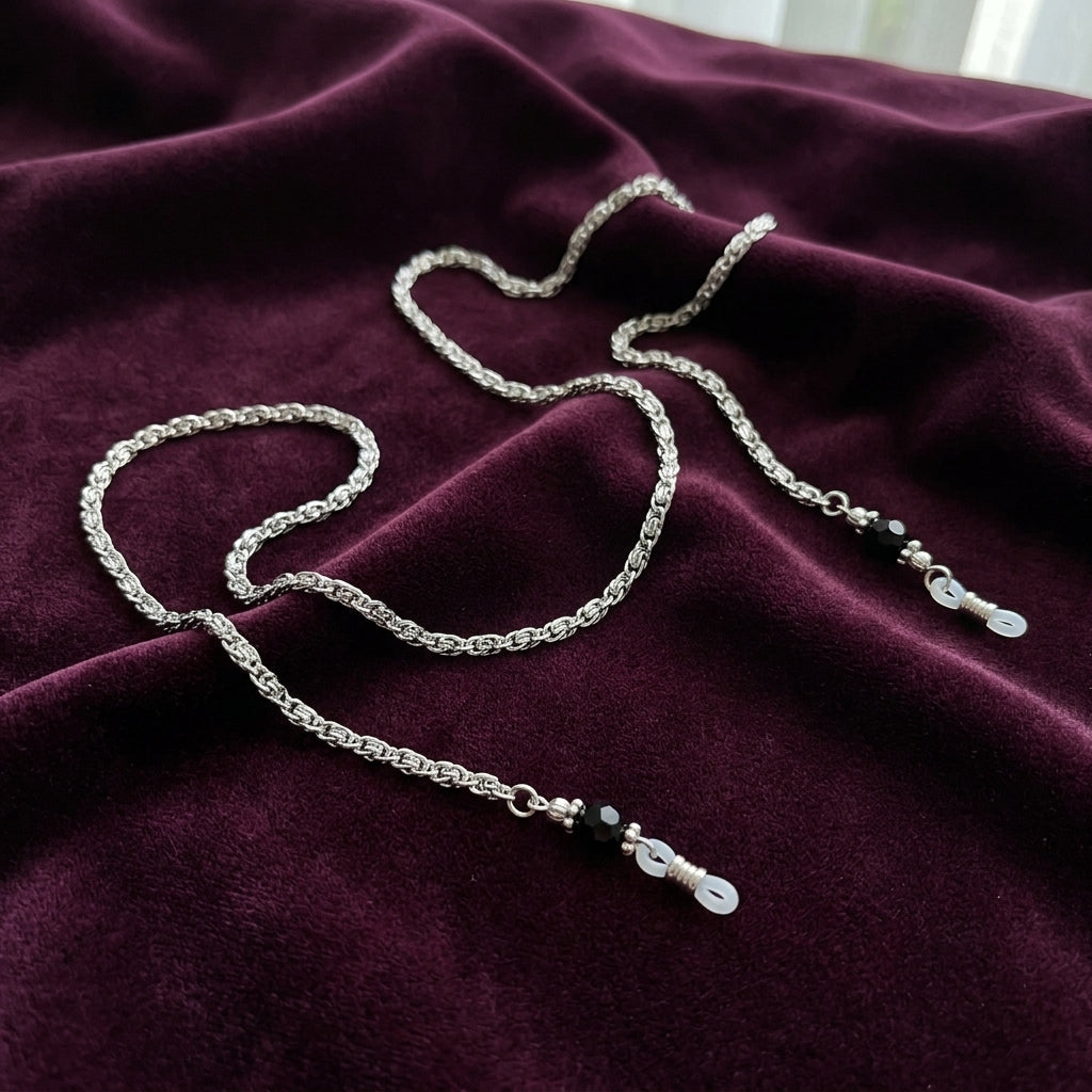 Scroll Chain Black Bead Eyeglass Holder Chain Necklace on a maroon fabric background