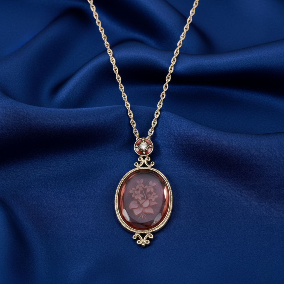 Gold necklace with a floral pendant on a blue fabric background