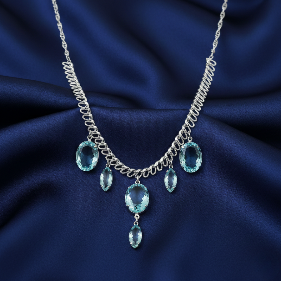 Necklace with aqua blue German crystals on a dark blue fabric background