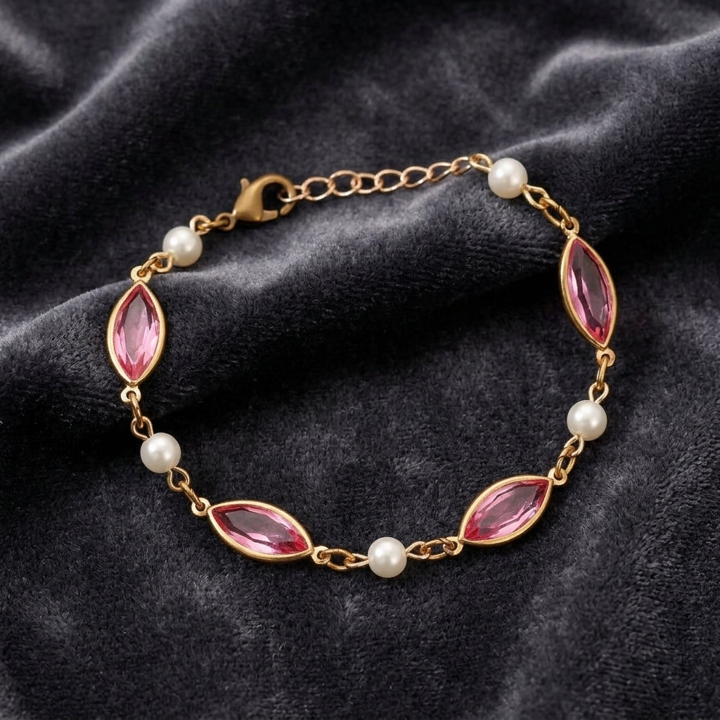 Navette Rose Pink Austrian Crystal & Faux Pearl Link Bracelet resting on dark gray fabric