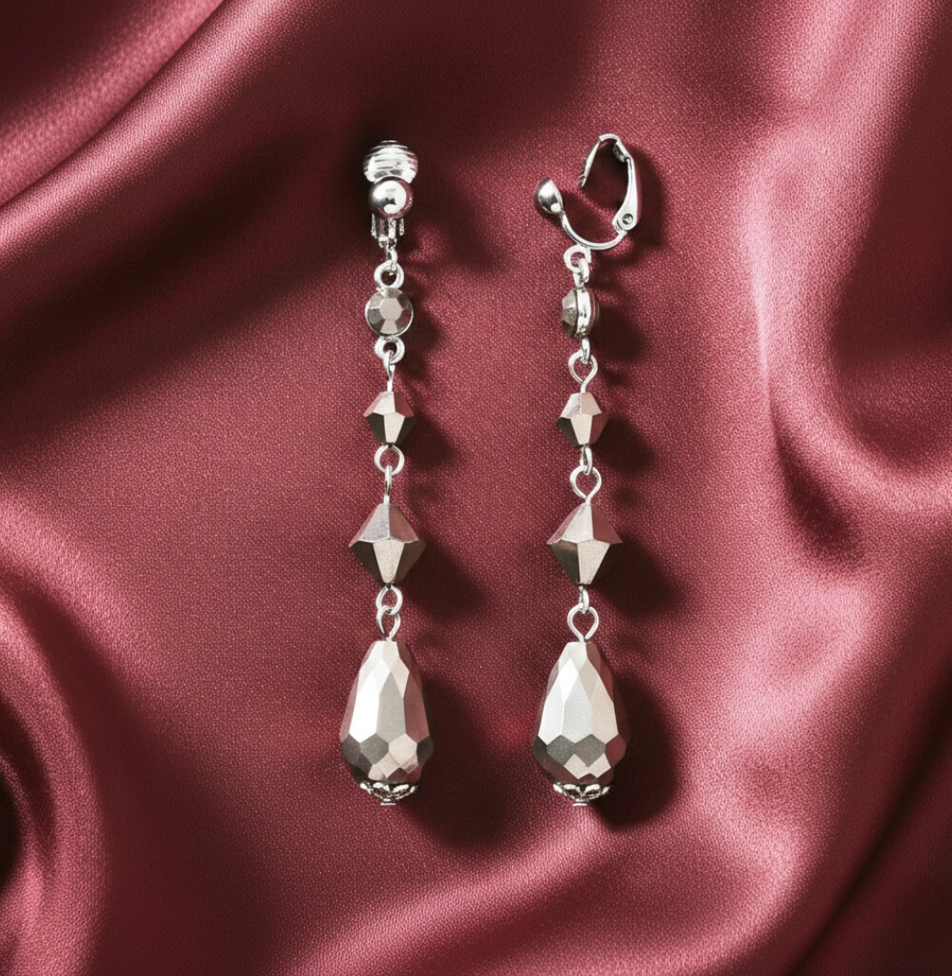 Silver earrings clip-on earrings on a burgundy satin background