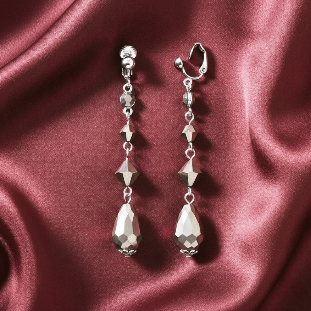 Silver earrings clip-on earrings on a burgundy satin background