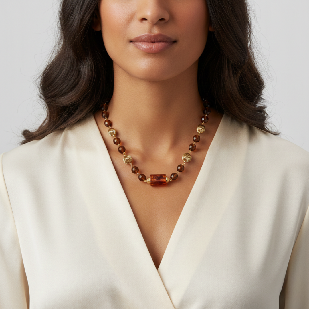 Woman wearing a topaz beaded necklace with a plain background