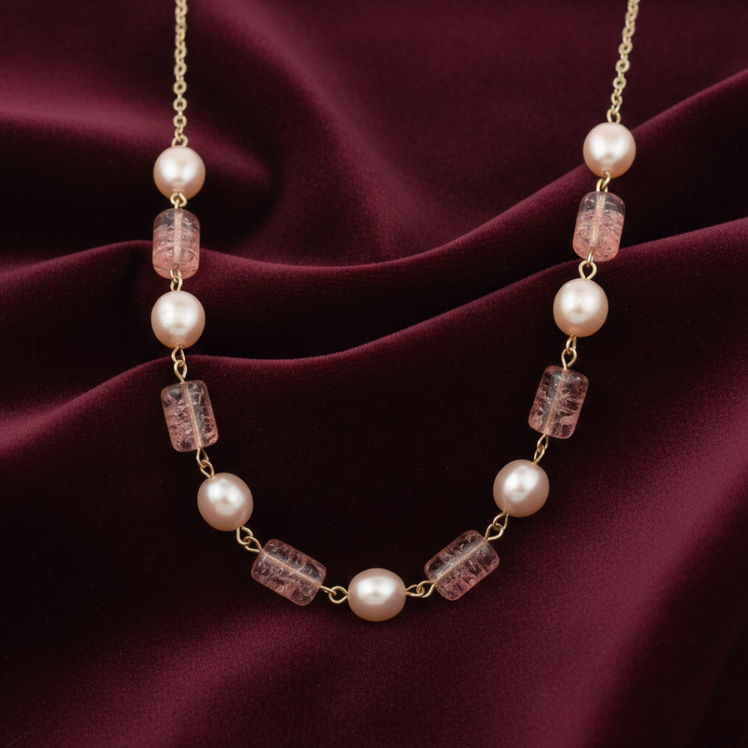 Necklace with pearls and pink beads on a burgundy fabric background