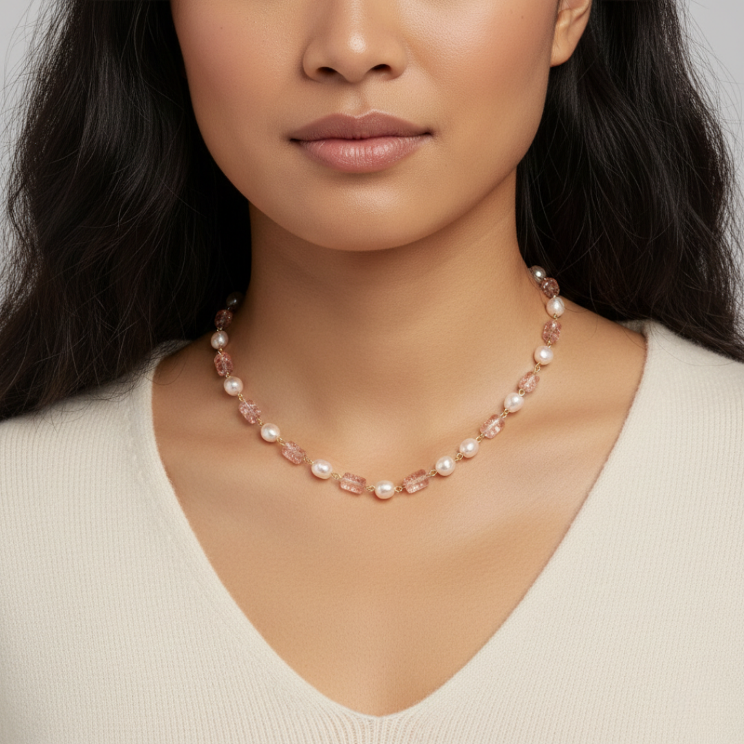 Woman wearing a pearl necklace against a neutral background