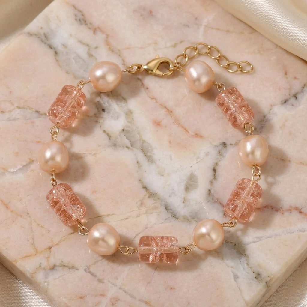 Pearl and pink bead bracelet on a marble surface