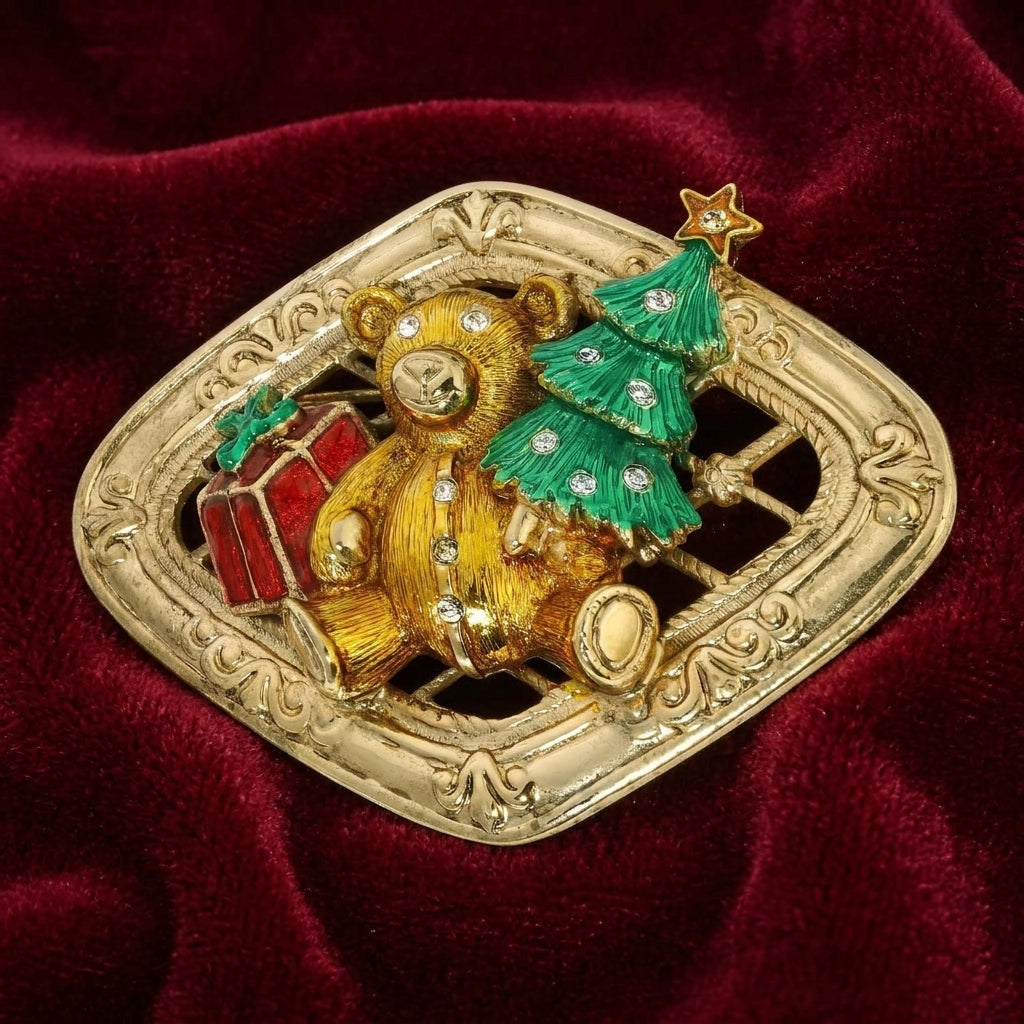 Gold brooch with a teddy bear and Christmas tree design on a red velvet background