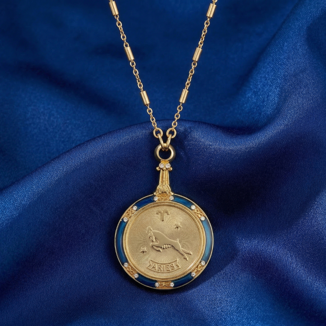 Gold necklace with a zodiac sign pendant on a blue fabric background