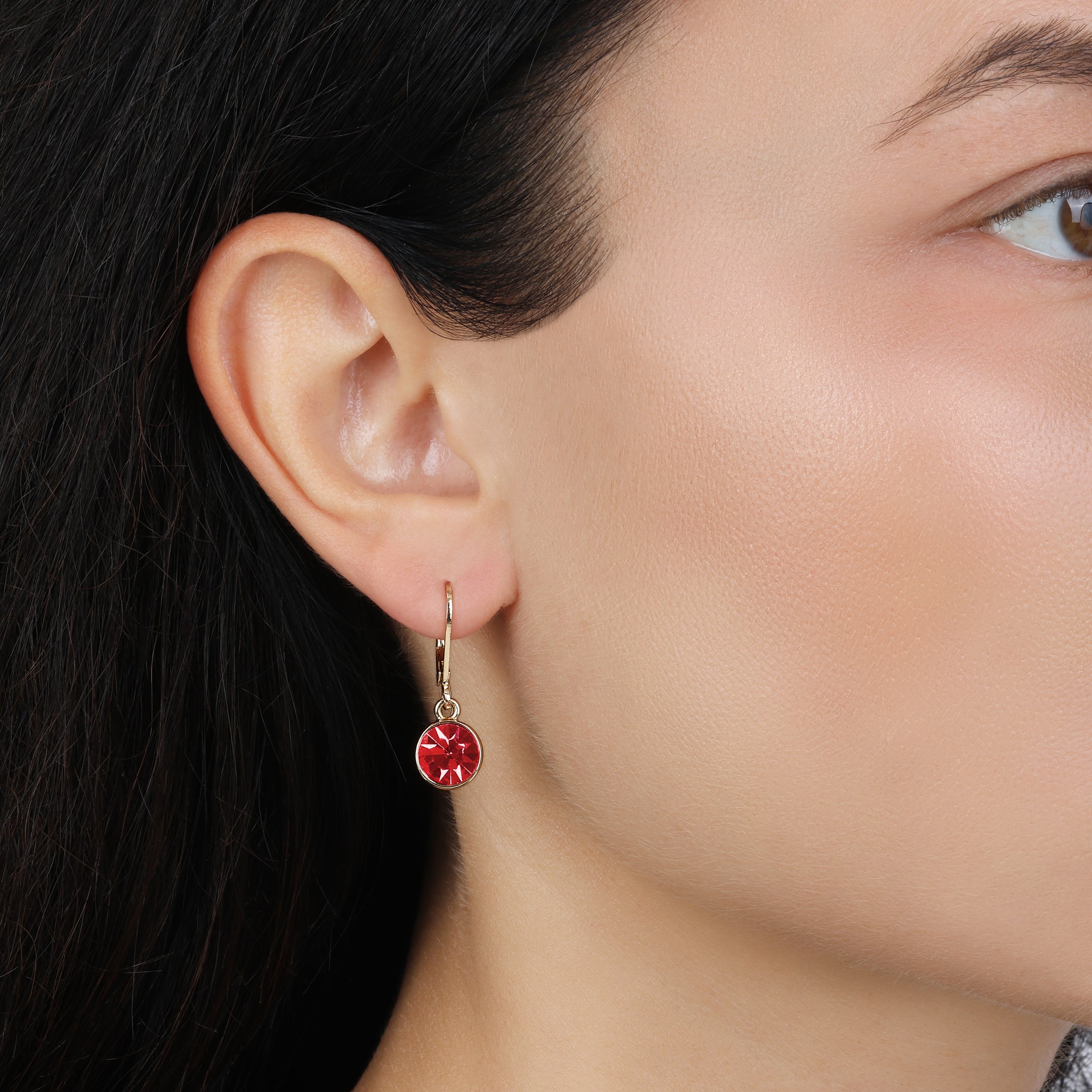 A close-up of a model's ear wearing a Classic Round Dark Pink Crystal Drop Earrings