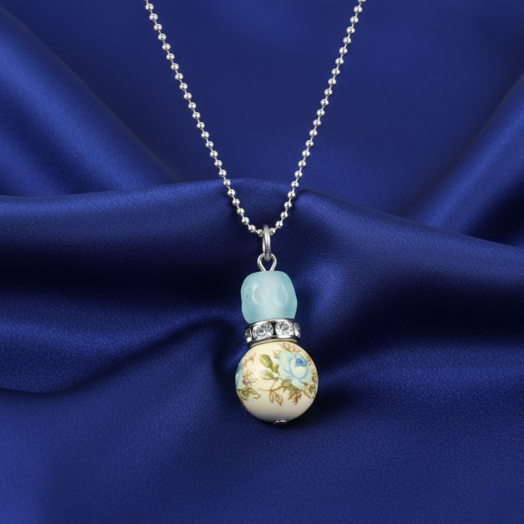 Necklace with a decorative pendant on a blue fabric background