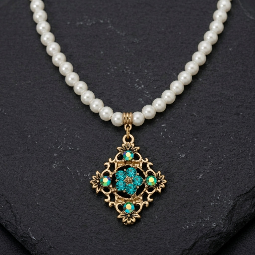 Pearl Strand Multi Crystal Filigree Pendant Necklace on a dark stone background