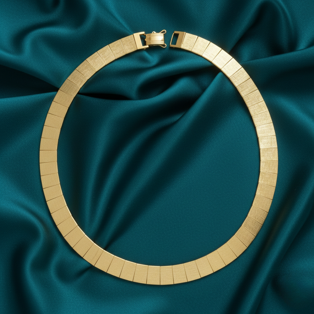 Gold necklace on teal satin fabric