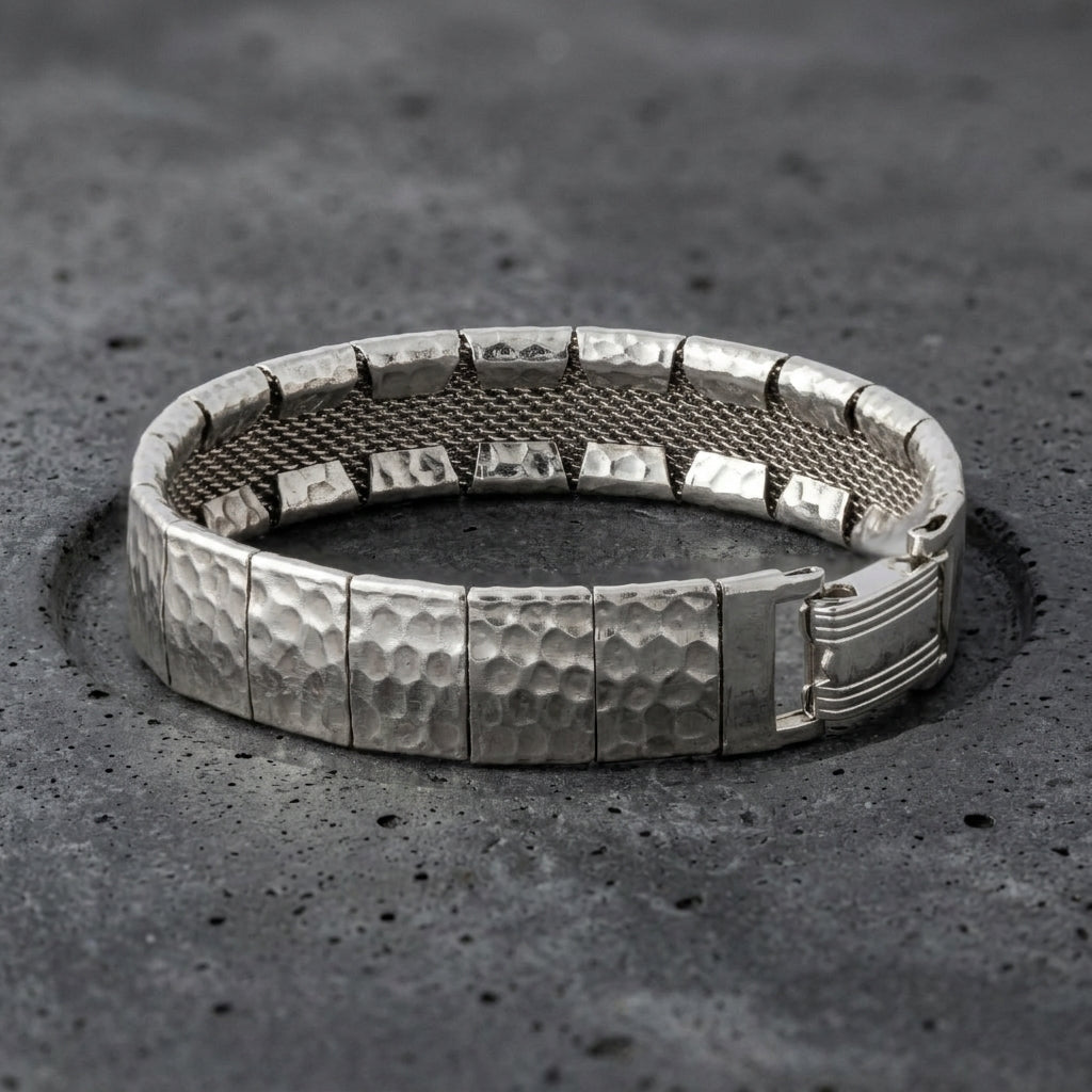 Silver Hammered Link Mesh Bracelet resting in a dark stone surface