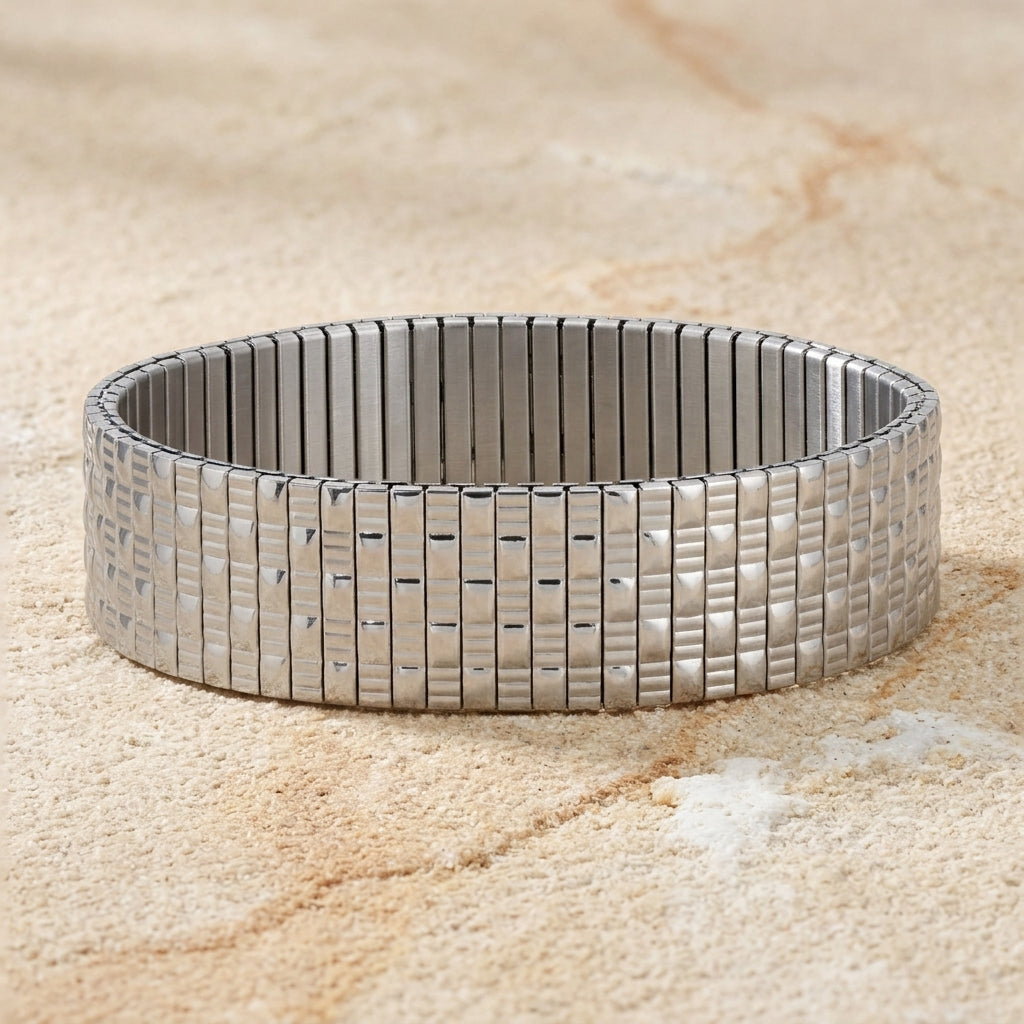 Silver Infinite Stretch Bracelet on a textured beige stone urface