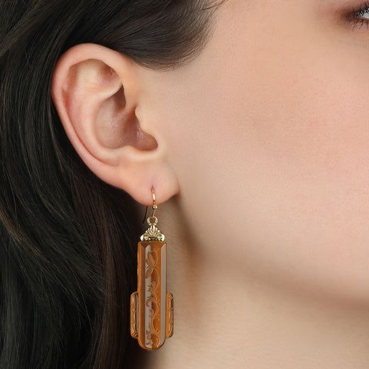 Woman wearing our Gold Tone and Brown Vintage Garden Motif Designed Glass Drop Earrings
