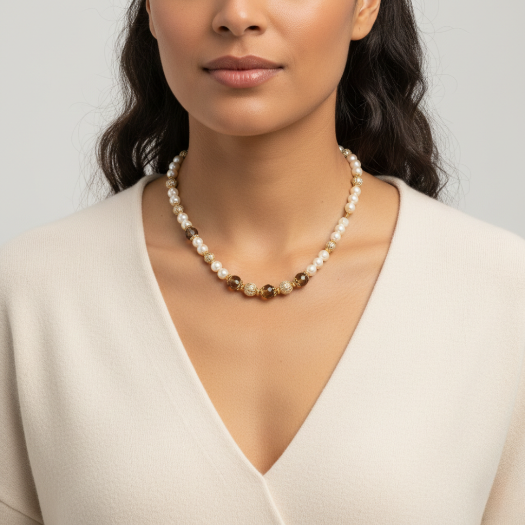 Woman wearing a pearl necklace against a plain background